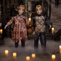 Witchwood™ 3 Ft. Animated Light-Up Apocalypse Twins with Stuffed Bear Halloween Decoration