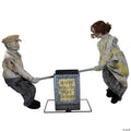 Witchwood™ Animated See-Saw Dolls Halloween Decoration - 36 in x 48 in