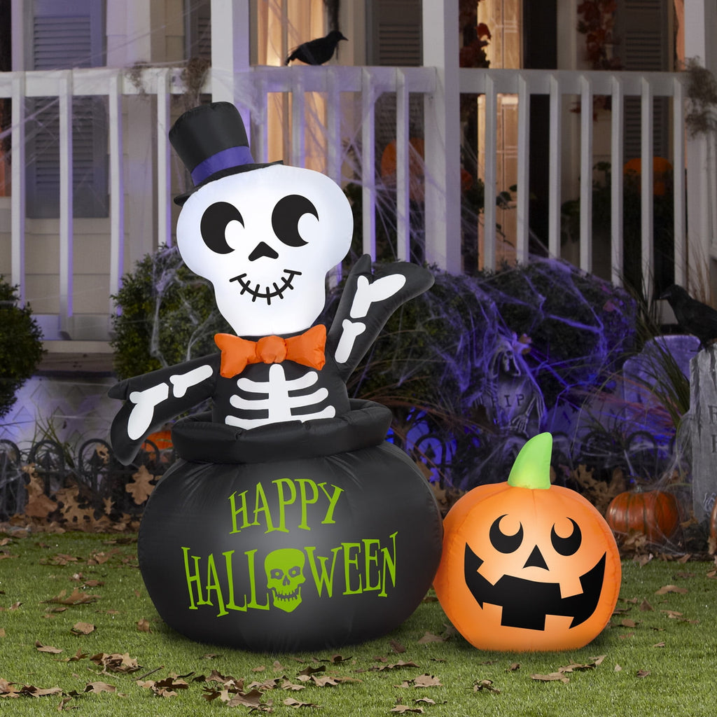 Witchwood™ Halloween Inflatable Skeleton in Cauldron, 4 ft Tall, Multi